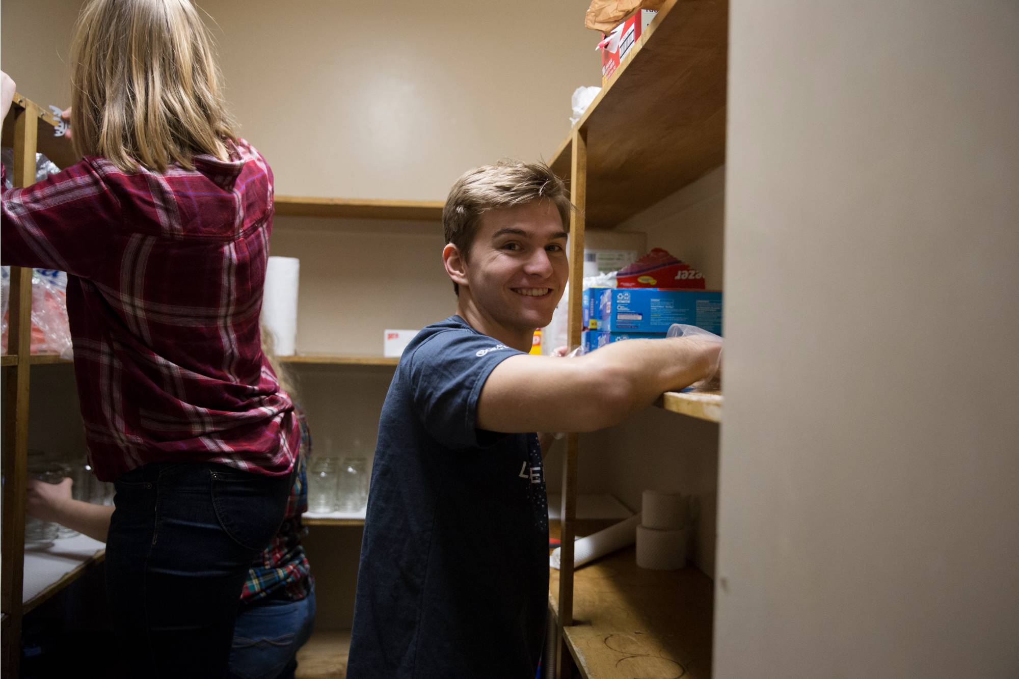A student wiping down shelves